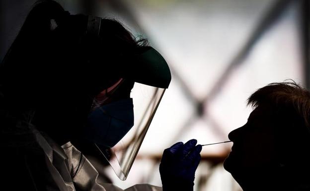 File photo of a health worker taking samples for a PCR. 