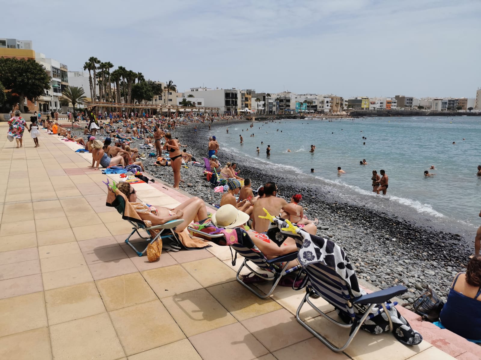 Bathers on the beach of Arinaga, in the south of Gran Canaria. 