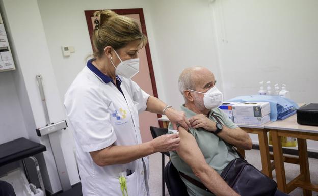 Imagen reciente de una sanitaria pinchando a un paciente que acudió a vacunarse de la gripe y la covid. 