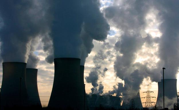 The cooling towers of the Fiddlers Ferry power station in Widnes, United Kingdom, spew thick columns of smoke into the atmosphere.